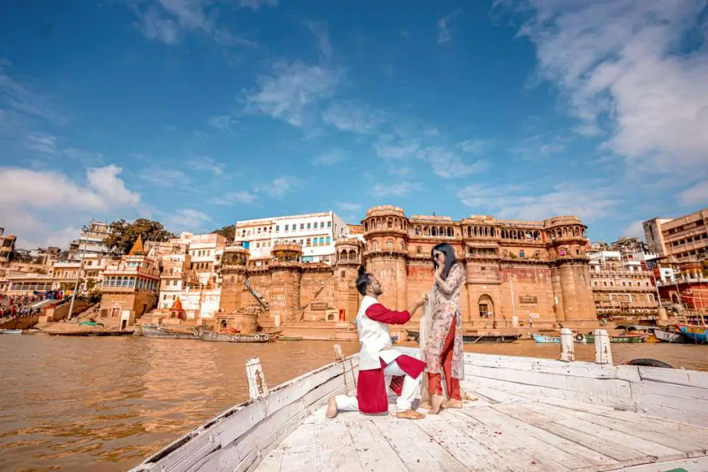 Romantic proposal style pre wedding photoshoot on boat near historic riverside architecture